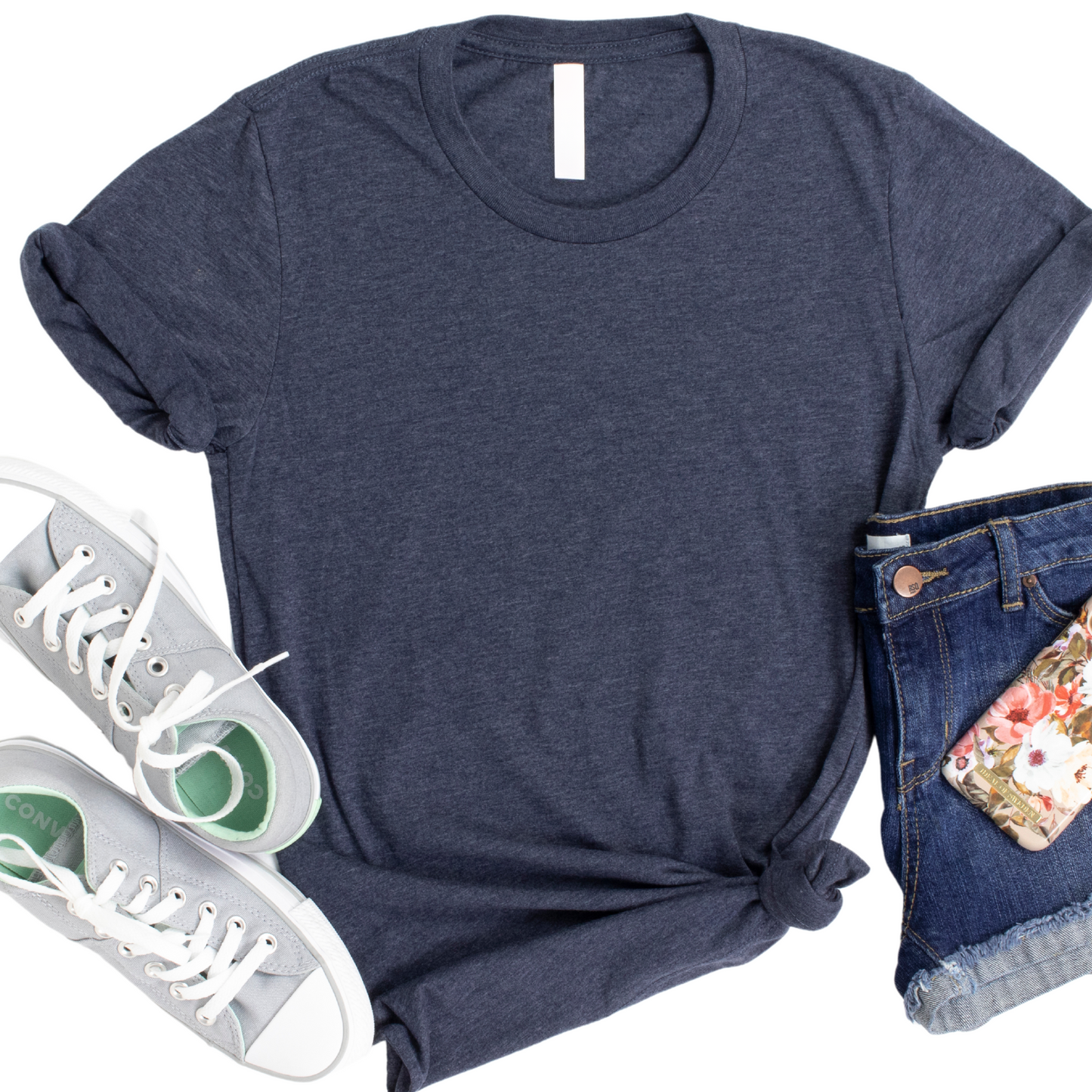 a t - shirt, jeans, and sneakers are laid out on a white surface