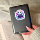 How To Scare Friends Funny Halloween Pink Ghost Reading  – 3" Waterproof Bookish Sticker with Holo Overlay – Reading, Books, Reader Gift, Book Lover