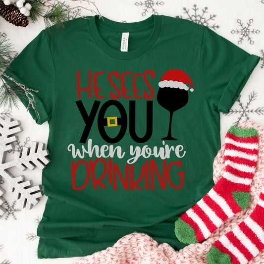 He Sees You When You’re Drinking Shirt or Sweatshirt – Funny Christmas Wine Top – S-4XL Plus Size – Multiple Colors