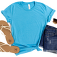 a t - shirt, jeans, and sandals are laid out on a white surface