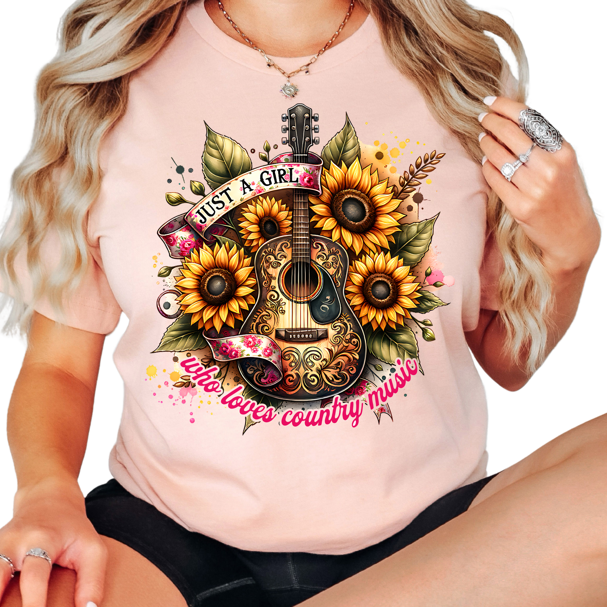 a woman wearing a pink shirt with sunflowers and a guitar