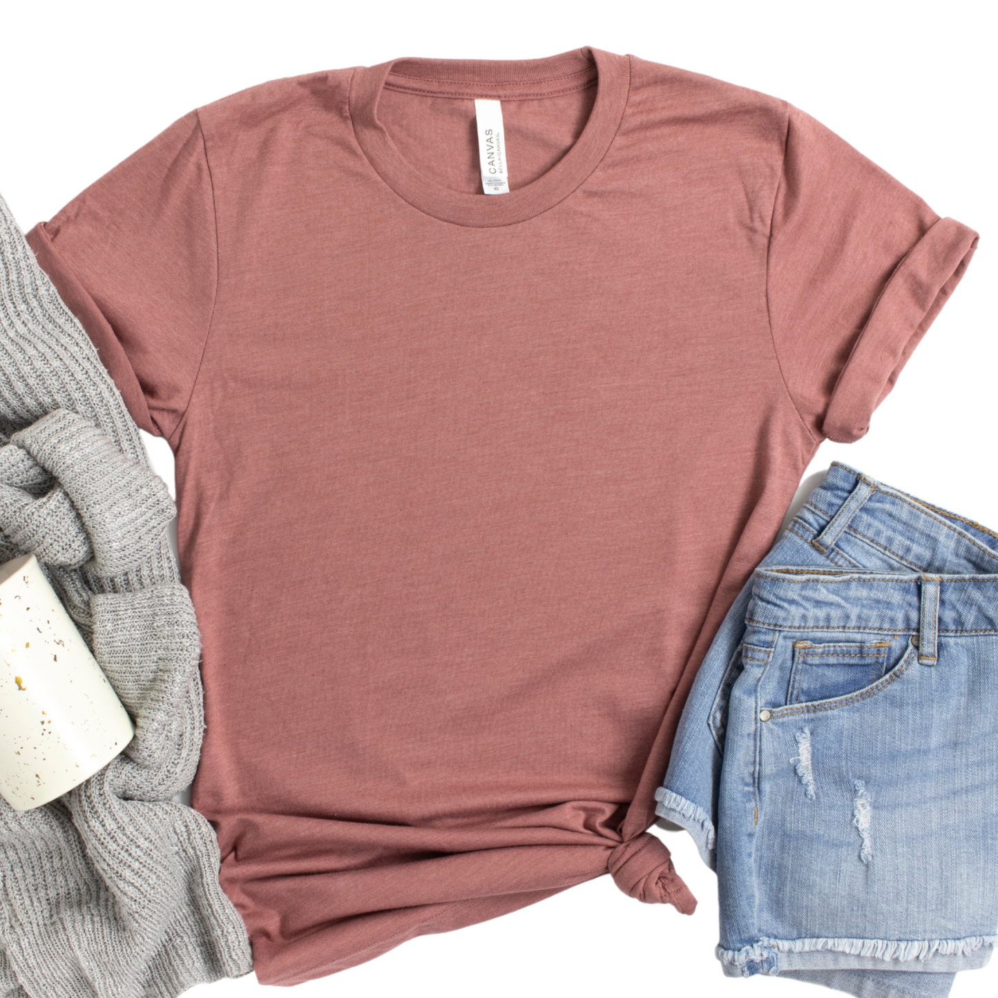 a t - shirt, jeans and a cup of coffee on a white background